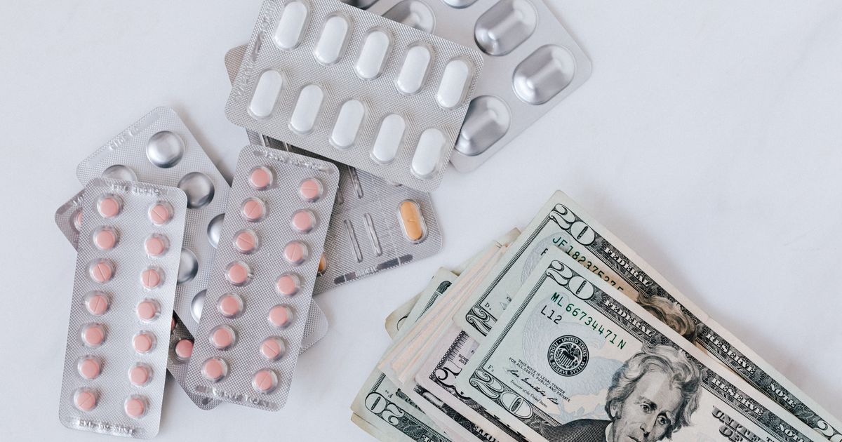Prescription medications next to dollar bills representing 2026 Medicare costs