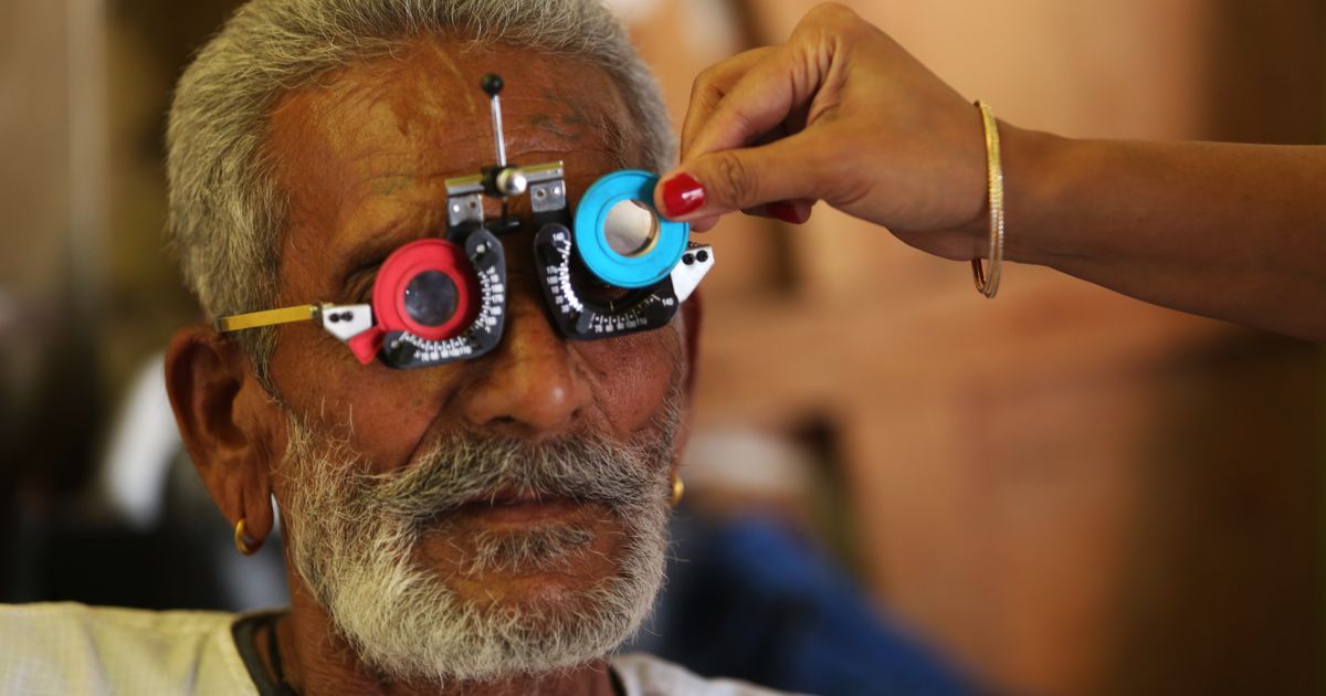 Senior man having a vision test with a trial lens frame during an eye exam