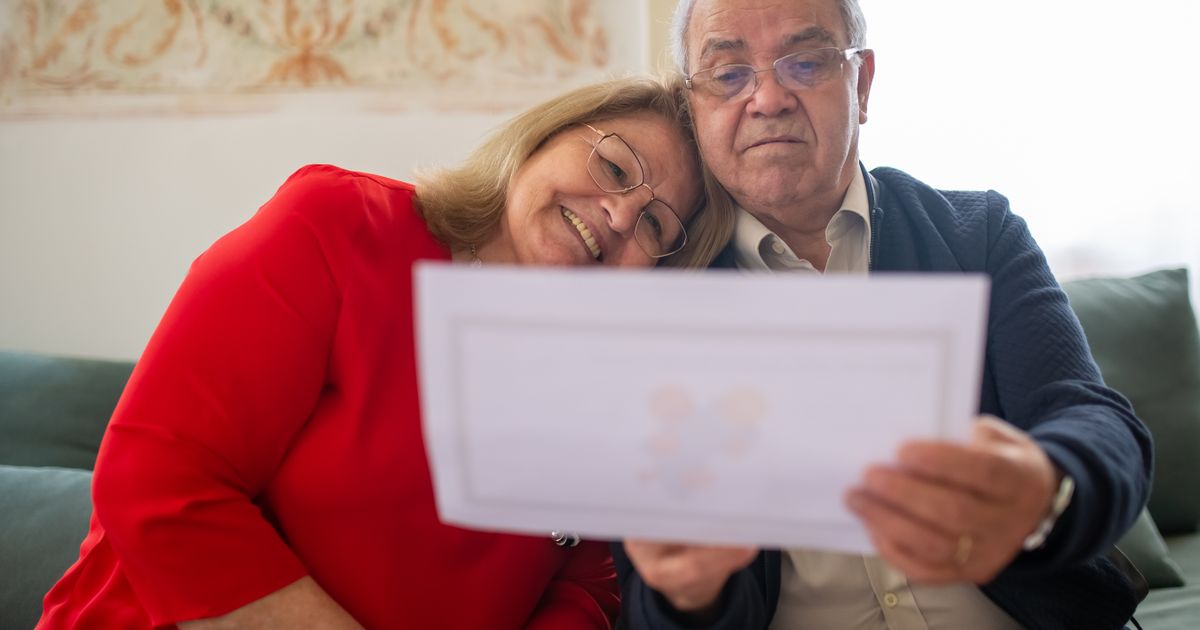 Senior couple at home reading a coverage letter together
