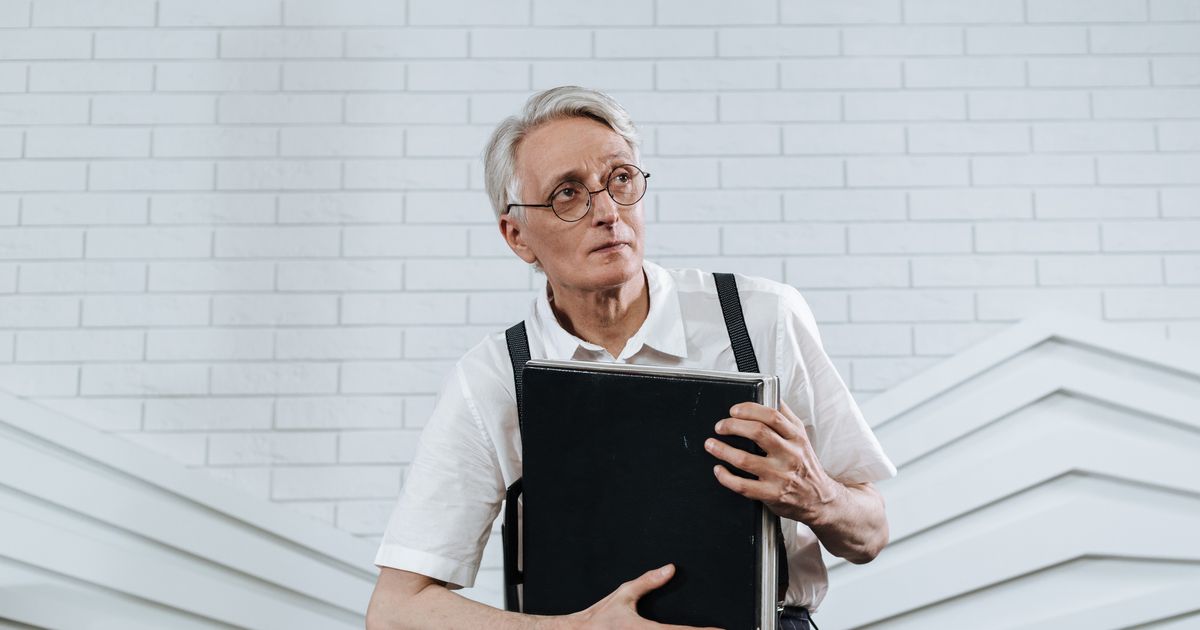 Senior professional with briefcase retiring from work