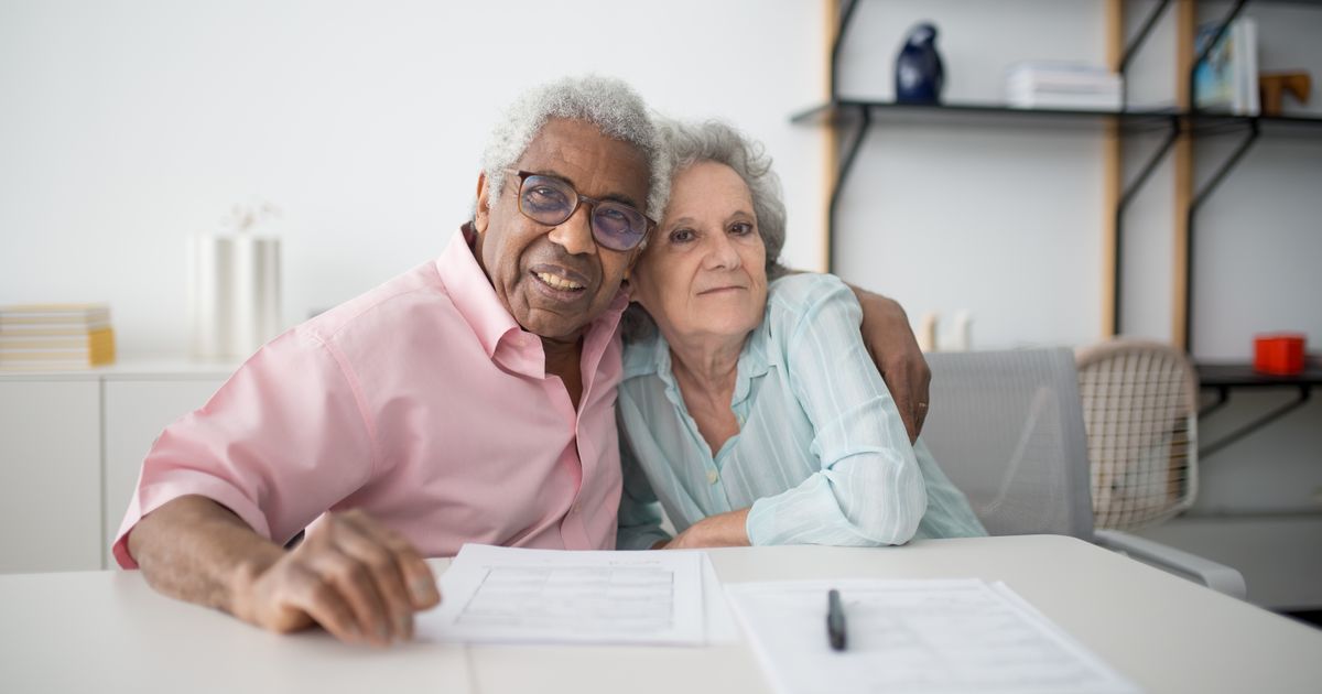 Senior couple reviewing Medicare enrollment paperwork together